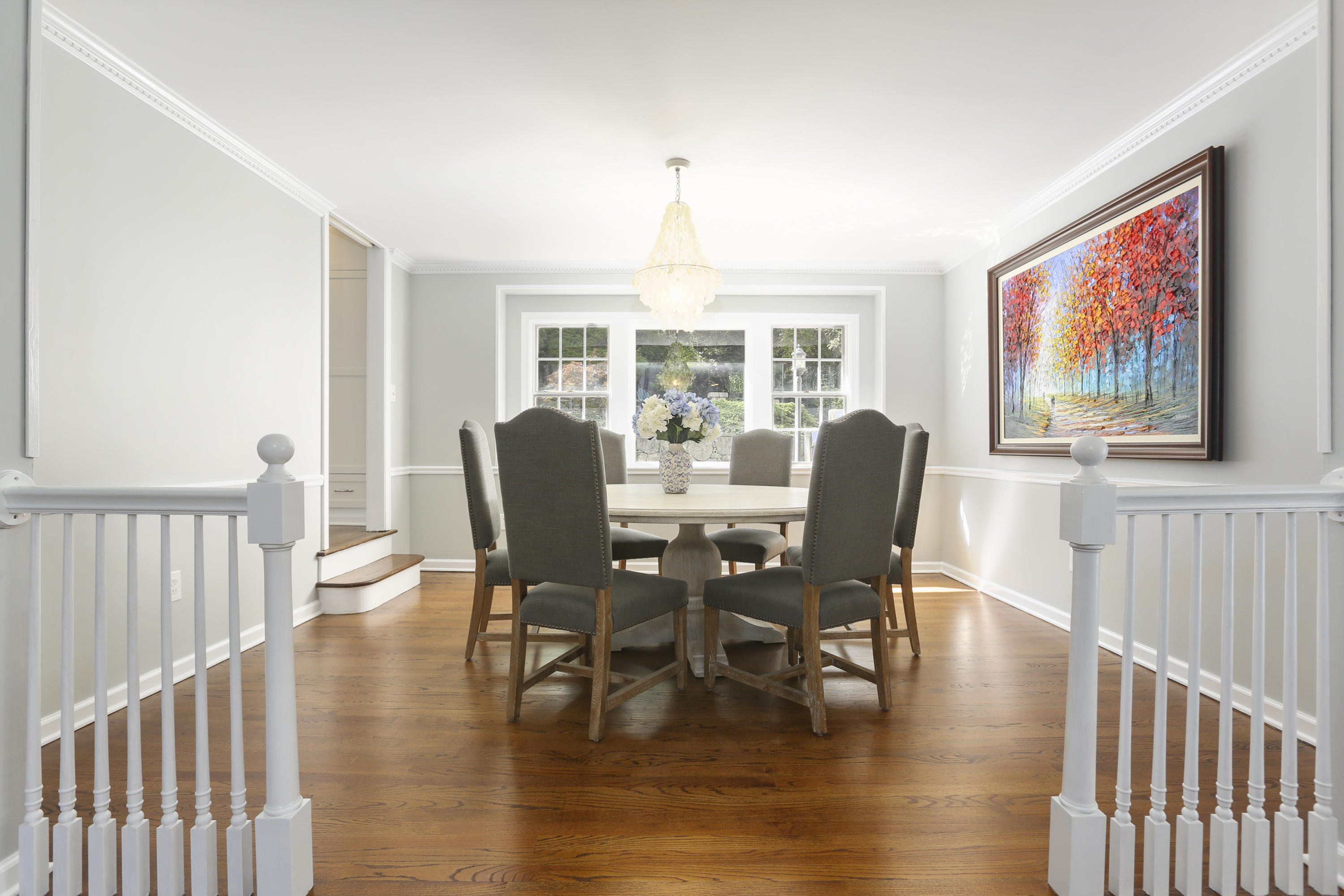 91 Gardiner Street Darien, CT 06820 - Photo 9 of 33 a dining room with furniture a chandelier and wooden floor