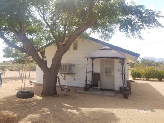 3735 West Ward Avenue Ridgecrest, CA 93555 - Photo 12 of 15 a view of a house with backyard and tree