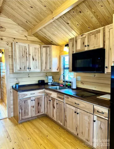 a kitchen with stainless steel appliances granite countertop a sink a stove and cabinets