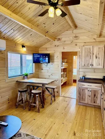 a kitchen with stainless steel appliances wooden floors stove and cabinets
