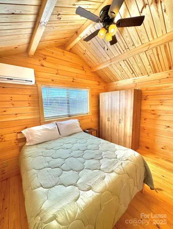 a bedroom with a bed and a painting on the wall