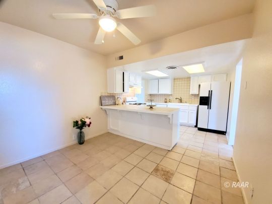 237 Sunset Place Ridgecrest, CA 93555 - Photo 3 of 17 a large white kitchen with a sink and cabinets