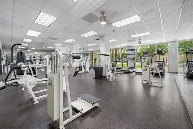 a gym room with lots of gym equipment
