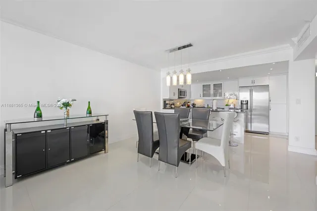 a view of a dining room with furniture and a kitchen