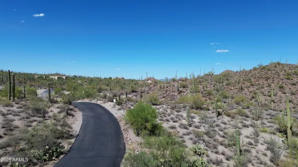 a view of a dry yard with mountains in the background