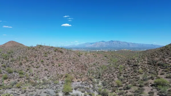 a view of a field with an ocean view