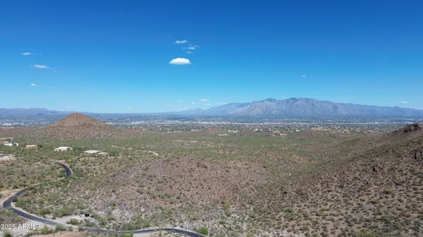 a view of a field with an ocean in the background