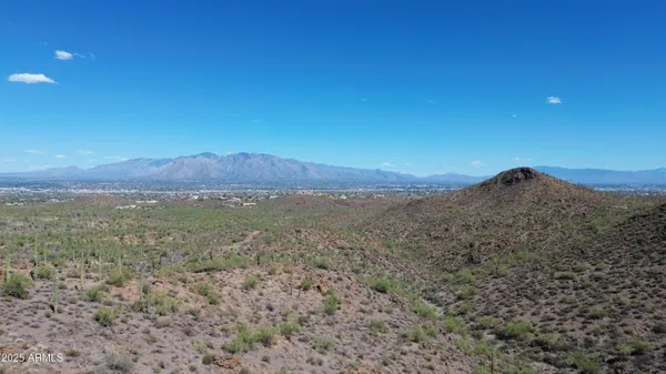 a view of a large mountain with mountains in the background