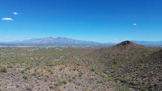 a view of a large mountain with mountains in the background