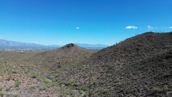a view of a mountain range with trees in the background