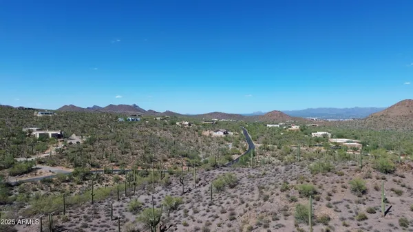 a view of a lush green hillside and a building