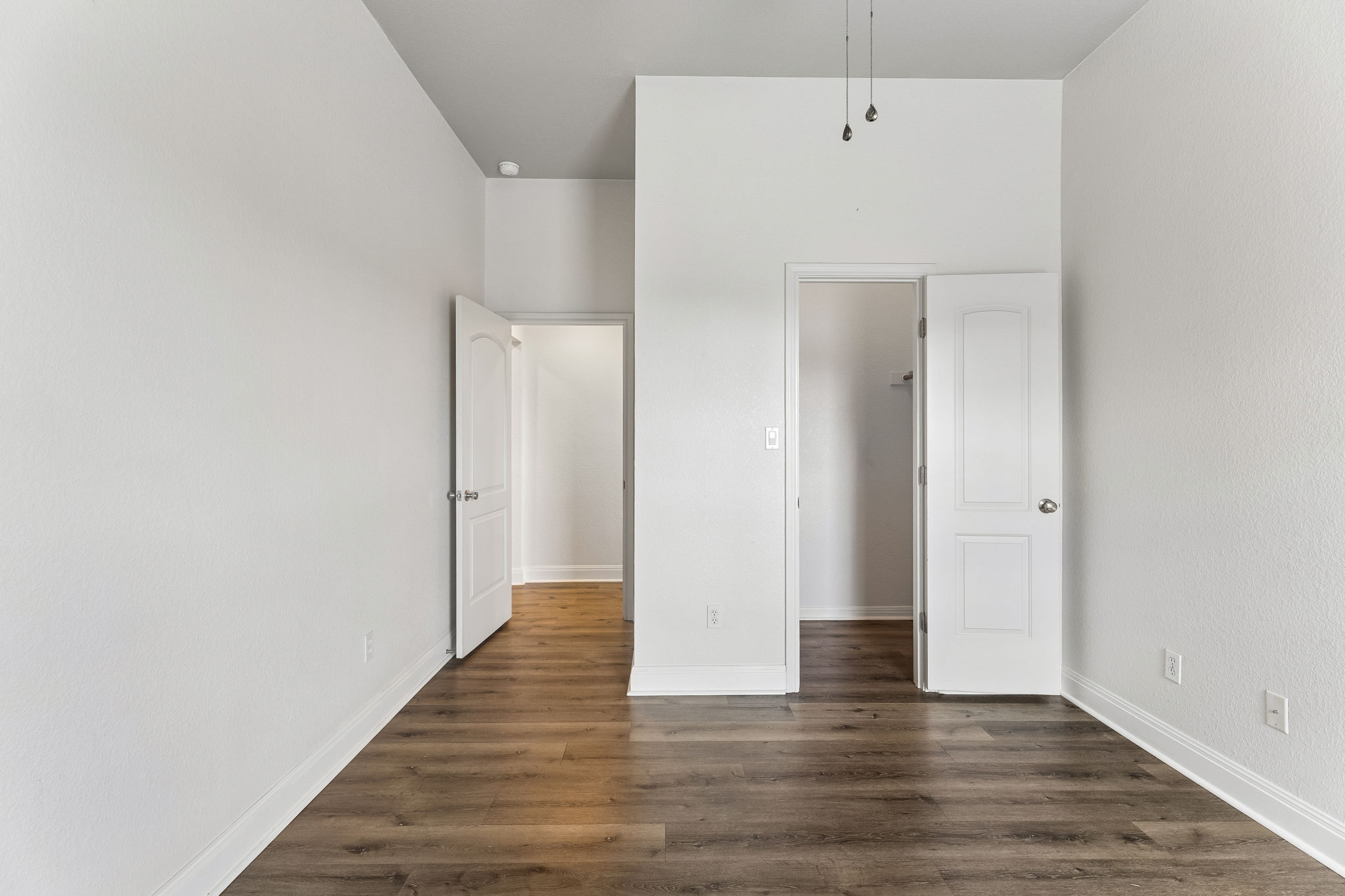 114 Aria Ridge, Unit 802 Lakeway, TX 78738 - Photo 18 of 37 Rich hardwood-style flooring extends across this spacious interior, connecting several inviting doorways.