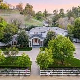 an aerial view of a house with a garden and lake view