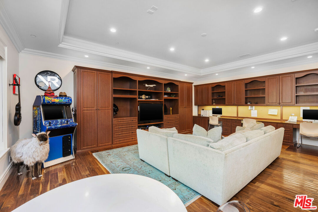 23924 Long Valley Road Hidden Hills, CA 91302 - Photo 20 of 46 a living room with fireplace furniture and a flat screen tv