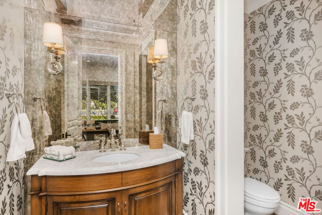 23924 Long Valley Road Hidden Hills, CA 91302 - Photo 21 of 46 a dining table with a bathroom sink and a mirror