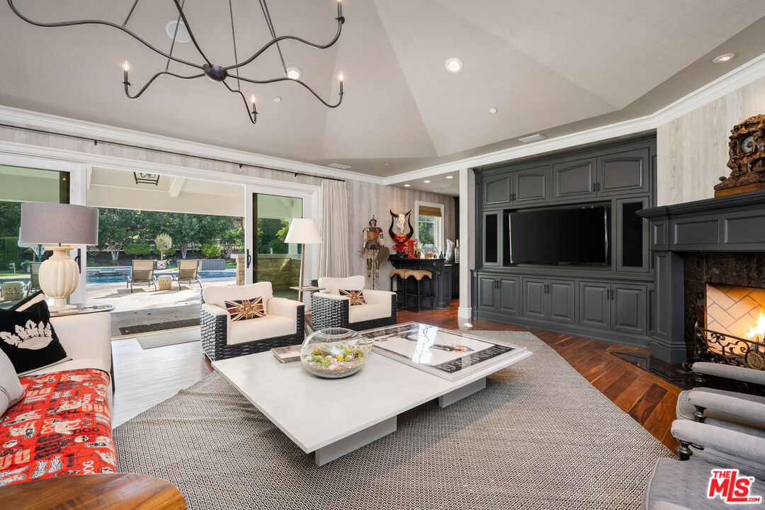 23924 Long Valley Road Hidden Hills, CA 91302 - Photo 22 of 46 a living room with fireplace furniture and a flat screen tv