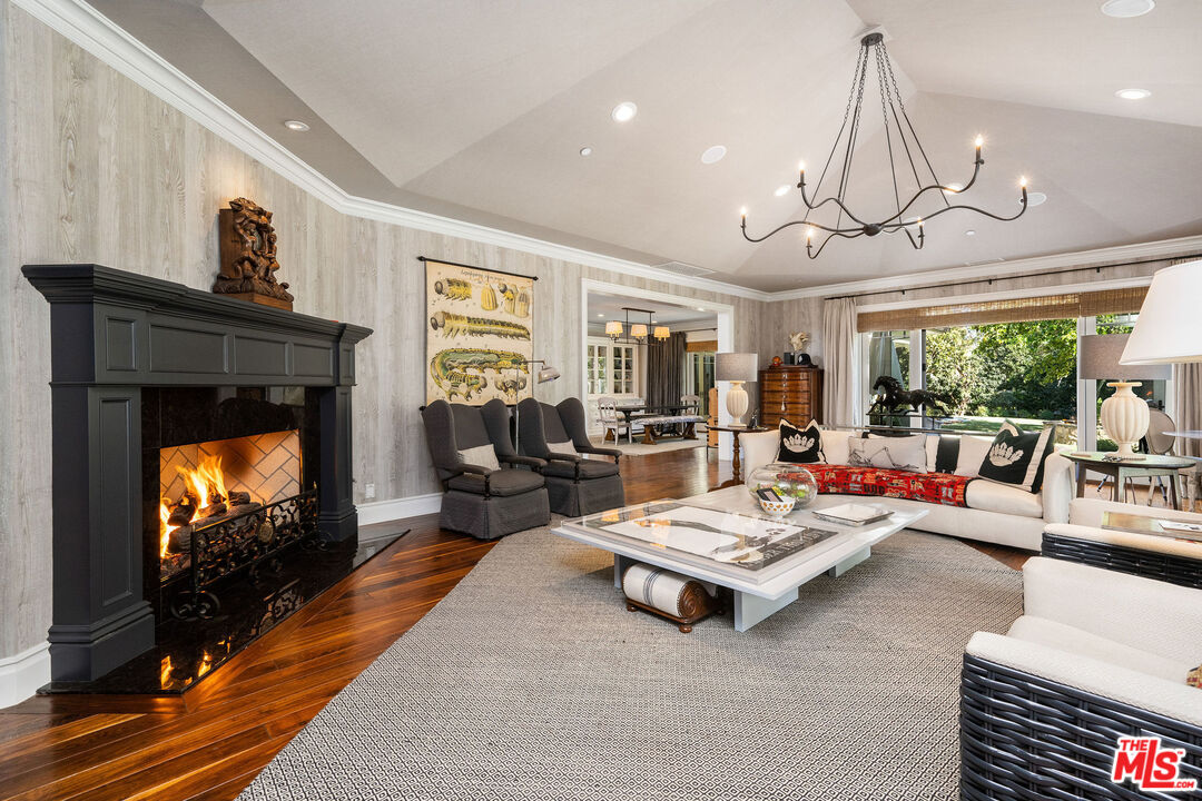 23924 Long Valley Road Hidden Hills, CA 91302 - Photo 23 of 46 a living room with furniture a rug and a flat screen tv
