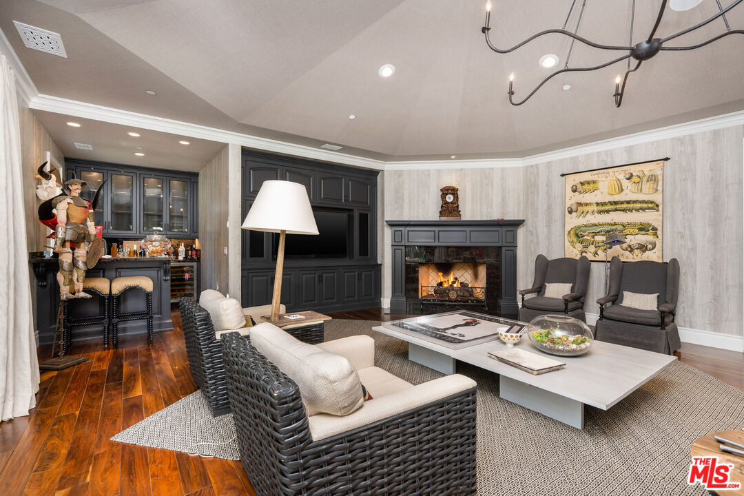 23924 Long Valley Road Hidden Hills, CA 91302 - Photo 24 of 46 a living room with furniture and a fireplace