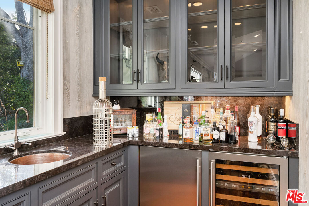 23924 Long Valley Road Hidden Hills, CA 91302 - Photo 25 of 46 a kitchen with granite countertop a sink and cabinets