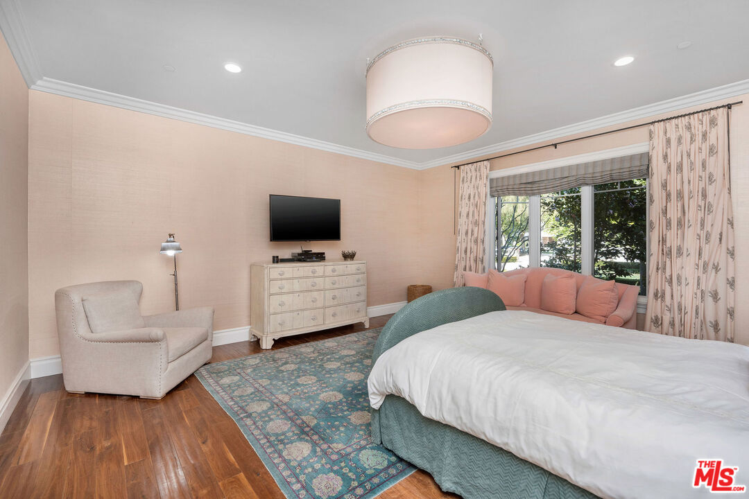 23924 Long Valley Road Hidden Hills, CA 91302 - Photo 28 of 46 a bedroom with a bed and a television