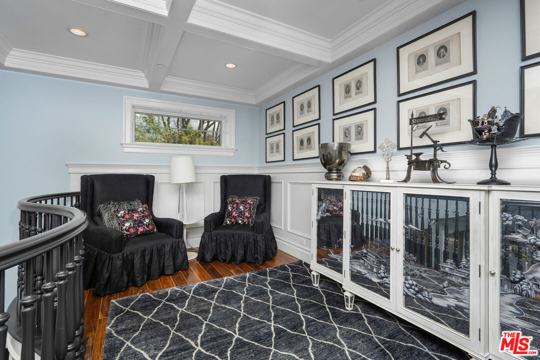 23924 Long Valley Road Hidden Hills, CA 91302 - Photo 29 of 46 a living room with furniture a rug and a wall painting