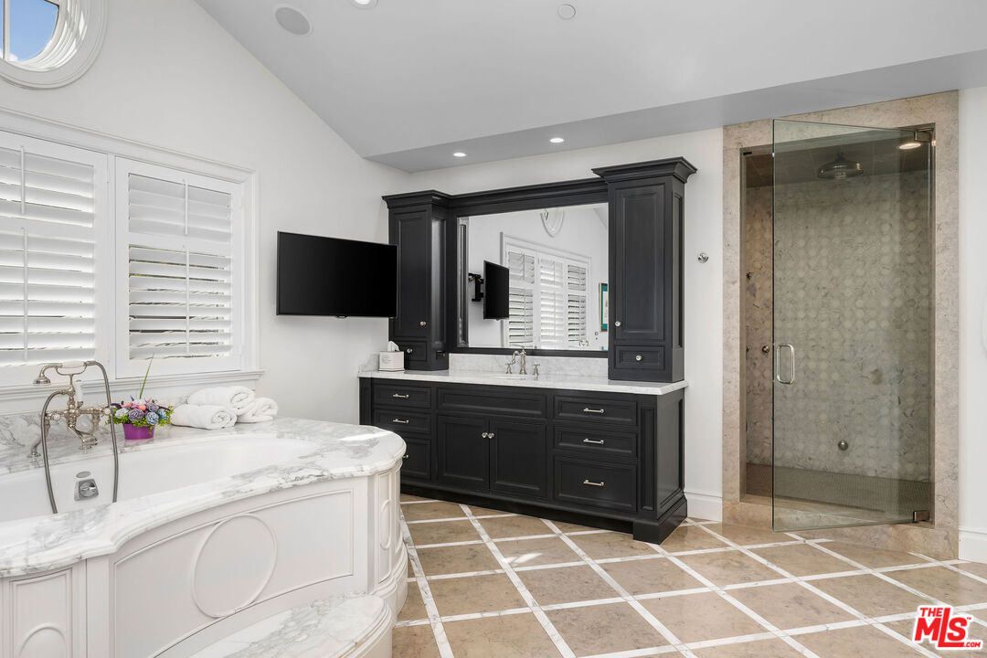 23924 Long Valley Road Hidden Hills, CA 91302 - Photo 35 of 46 a bathroom with a sink vanity and a mirror