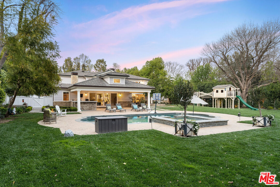 23924 Long Valley Road Hidden Hills, CA 91302 - Photo 39 of 46 a front view of a house with garden and trees