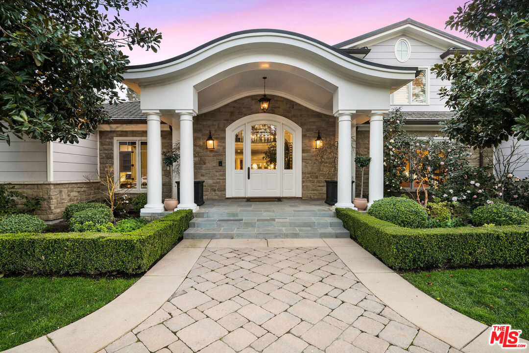 23924 Long Valley Road Hidden Hills, CA 91302 - Photo 4 of 46 a front view of a house with garden