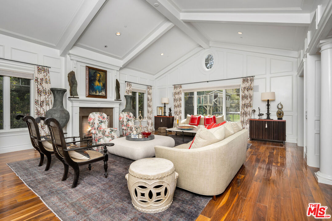 23924 Long Valley Road Hidden Hills, CA 91302 - Photo 8 of 46 a living room with fireplace furniture and a wooden floor