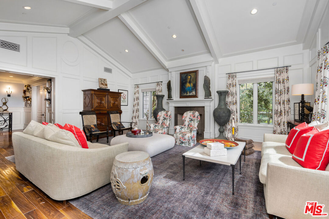 23924 Long Valley Road Hidden Hills, CA 91302 - Photo 9 of 46 a living room with furniture fireplace and a large window