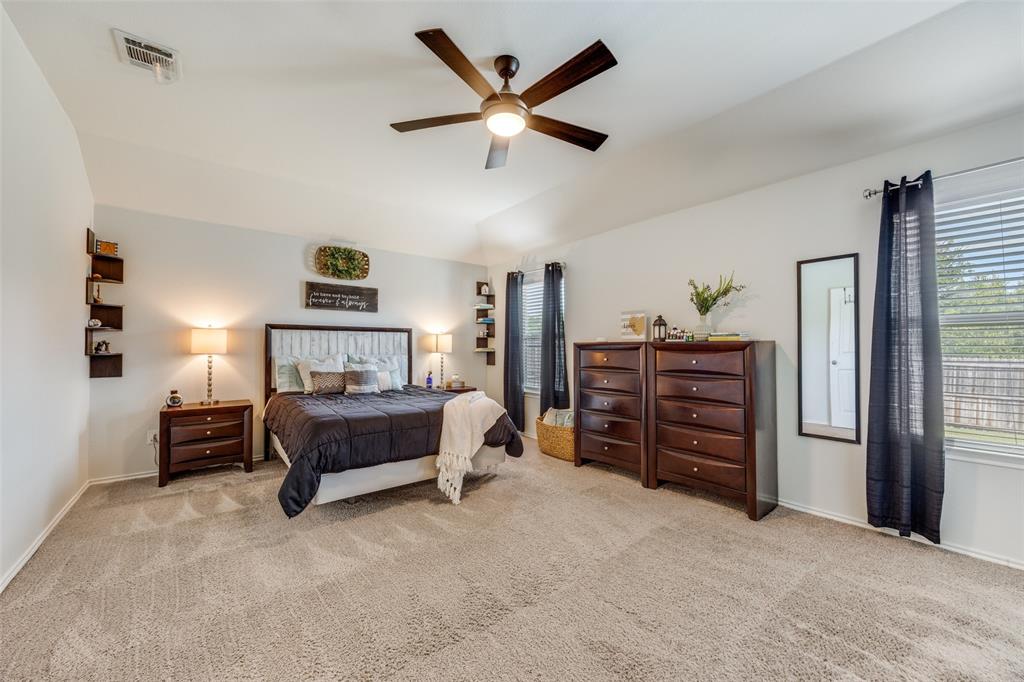 1011 Riverstone Trail Princeton, TX 75407 - Photo 11 of 26 a spacious bedroom with a bed and a ceiling fan
