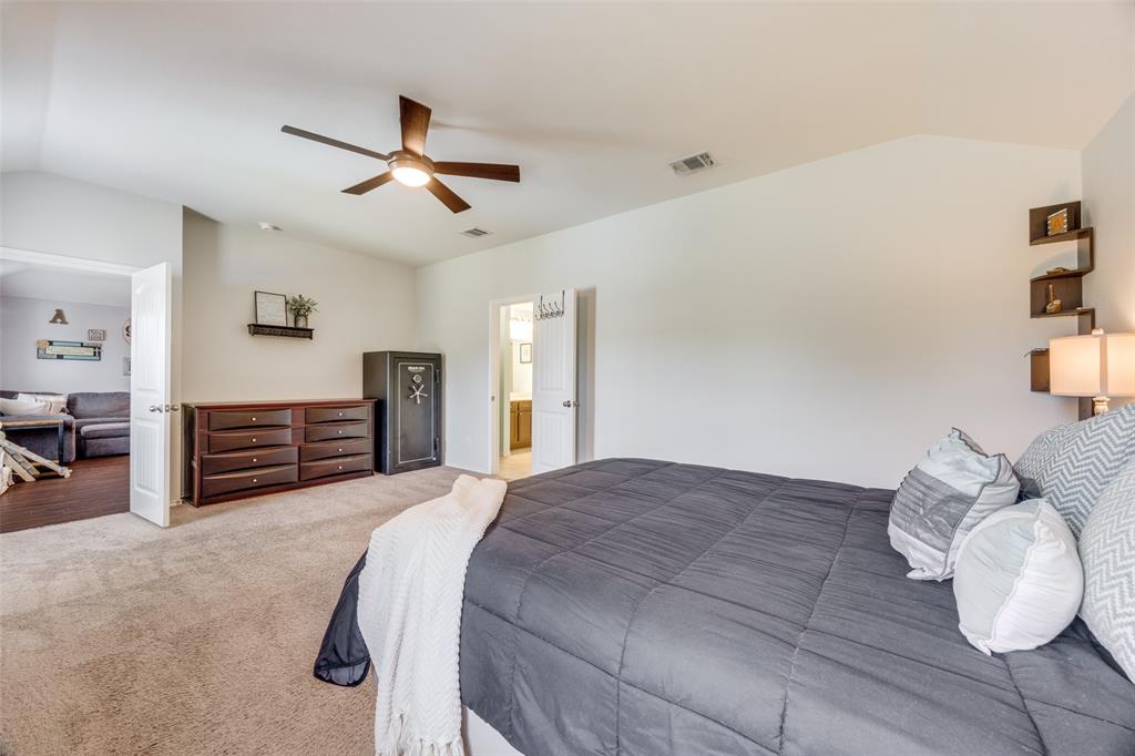 1011 Riverstone Trail Princeton, TX 75407 - Photo 12 of 26 a bedroom with a bed and dresser