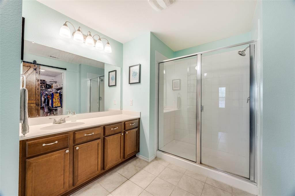 1011 Riverstone Trail Princeton, TX 75407 - Photo 13 of 26 a spacious bathroom with a shower sink and mirror