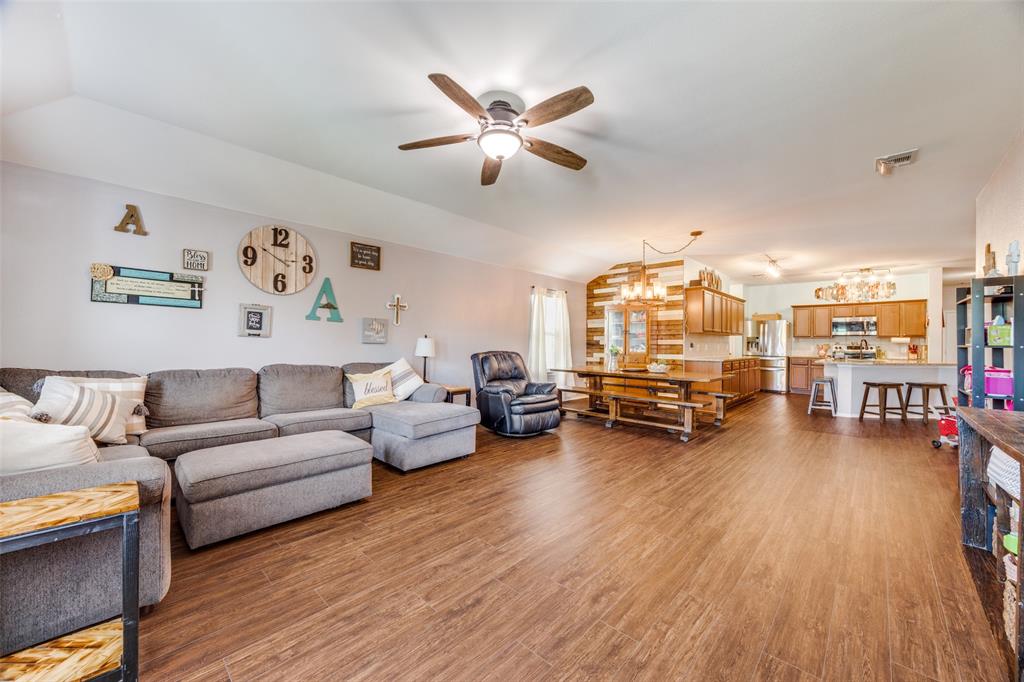 1011 Riverstone Trail Princeton, TX 75407 - Photo 6 of 26 a living room with furniture and a large window with wooden floor