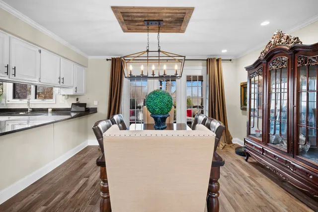 a living room with kitchen island furniture and a chandelier