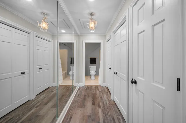 a view of a hallway with wooden floor and staircase