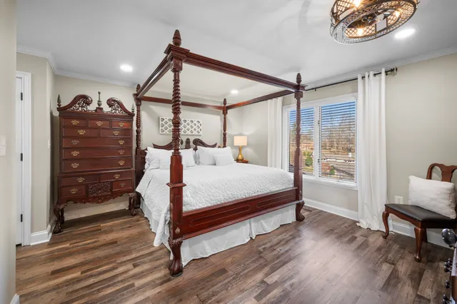 a bedroom with a bed and a chandelier