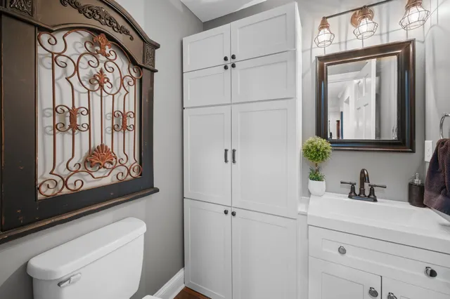a bathroom with a toilet a sink and a mirror