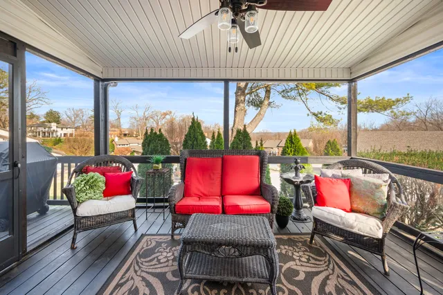 a reading room with wooden floor pool table and a couch