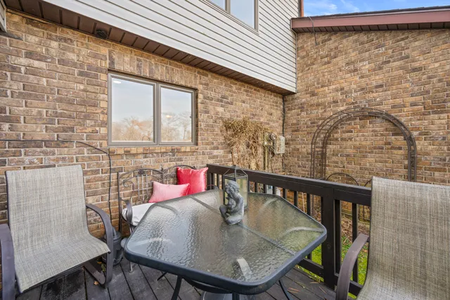 a balcony with table and chairs