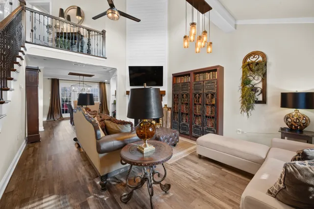 a living room with furniture a rug and a bookshelf