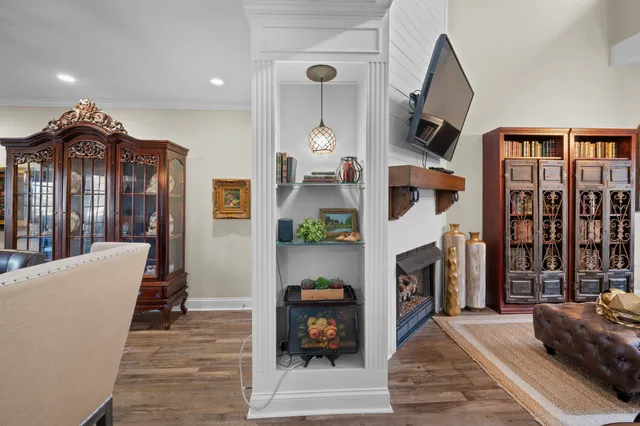 a living room with furniture a fireplace and a chandelier