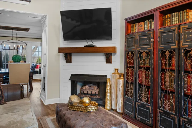 a living room with furniture fireplace and flat screen tv