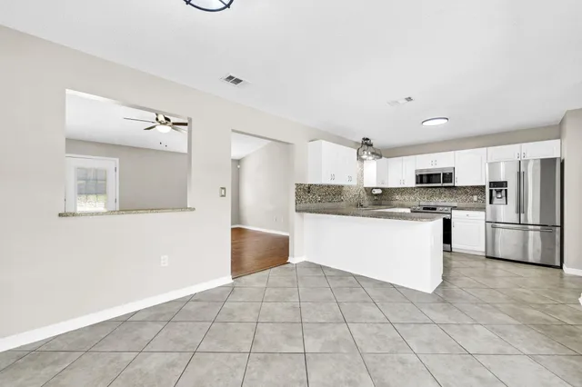 a kitchen with stainless steel appliances a refrigerator sink and cabinets