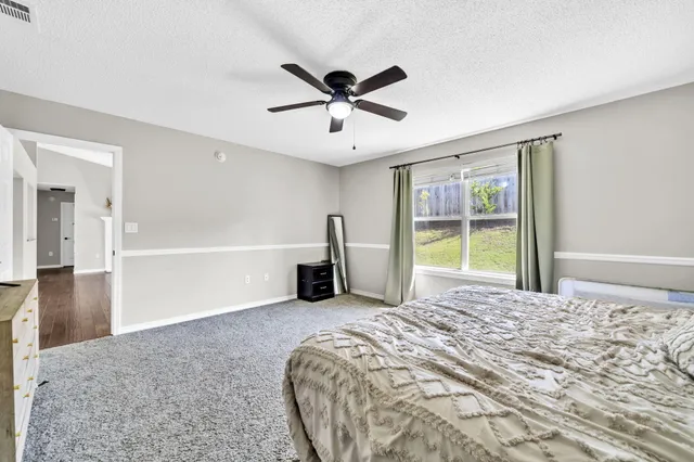 a view of a bedroom with a bed and a window