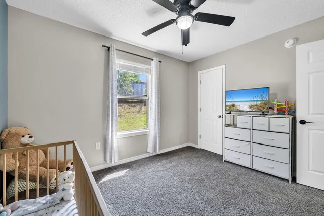 a view of a hallway with workspace and a window