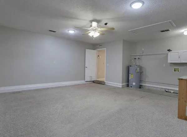 an empty room with a ceiling fan and window