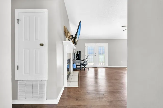 a view of empty room with wooden floor
