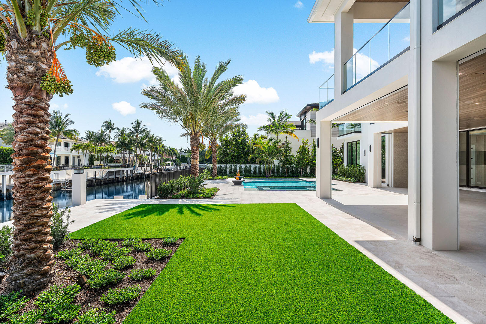 191 Coconut Palm Road Boca Raton, FL 33432 - Photo 29 of 81 a view of a patio with table and chairs potted plants and palm tree