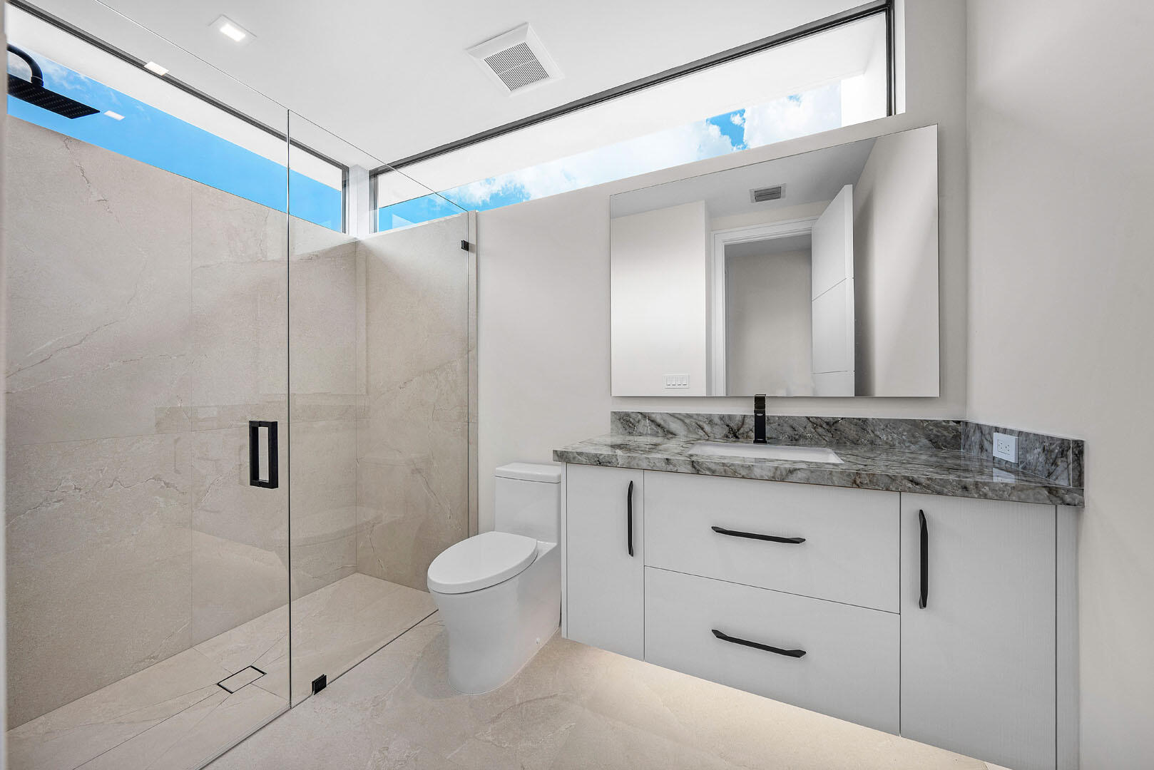 191 Coconut Palm Road Boca Raton, FL 33432 - Photo 54 of 81 a bathroom with a granite countertop sink a toilet and a mirror